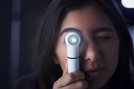 Female doctor using otoscope for examinationの写真素材