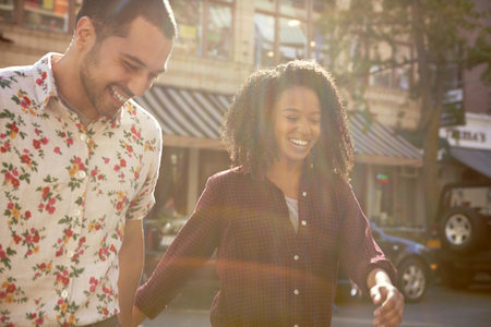 Young Couple Crossing Urban Street In New York Cityの写真素材
