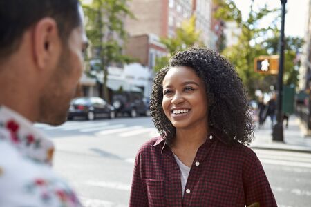 Young Couple Walking Along Urban Street In New York Cityの写真素材