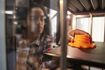 Female College Student Printing 3D Object In Design Lesson