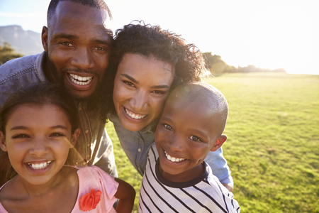 Portrait of a smiling black family outdoors, close upの写真素材