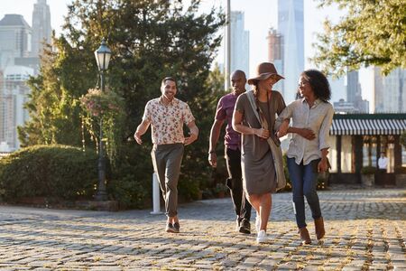 Group Of Friends Walking With Manhattan Skyline In Backgroundの写真素材