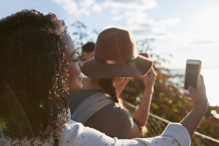 Group Of Tourists Taking Photos On Mobile Phonesの写真素材