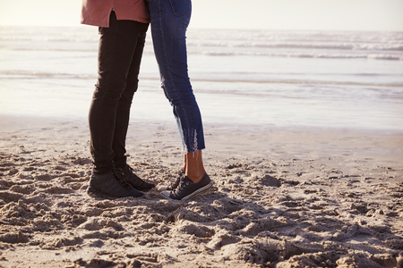 Detail Of Romantic Couple On Walking Along Winter Beach Togetherの写真素材