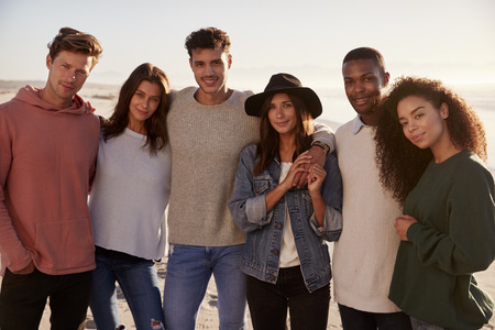 Portrait Of Friends On Walking Along Winter Beach Togetherの写真素材