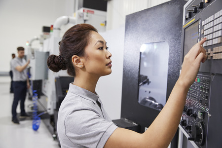 Female Engineer Operating CNC Machinery In Factoryの写真素材