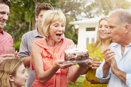 Multi Generation Family Celebrating Birthday In Gardenの写真素材