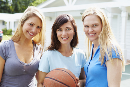 Portrait Of Young Women Playing Basketball Matchの写真素材