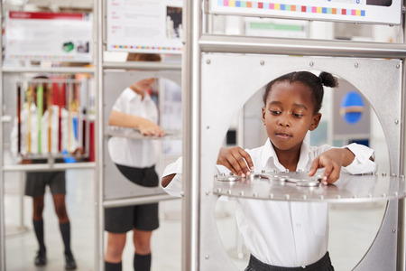 School kids taking part in science tests at a science centreの写真素材