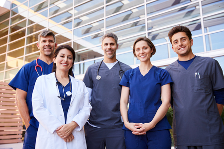Five healthcare colleagues standing outdoors, group portraitの写真素材