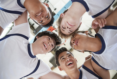 Low Angle View Of Male High School Basketball Players Having Team Talkの写真素材