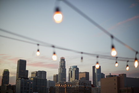 View Of Los Angeles Skyline At Sunset  With String Of Lights In Foregroundの写真素材