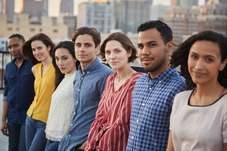 Portrait Of Friends Gathered On Rooftop Terrace For Party With City Skyline In Backgroundの写真素材