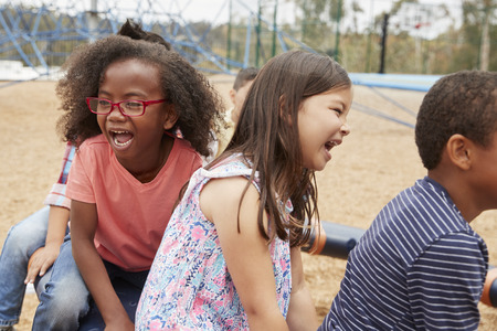Elementary school kids playing in playground, close upの写真素材