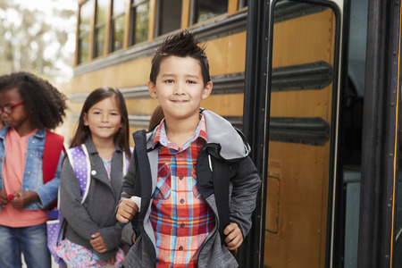 Elementary school kids queueing for the school bus