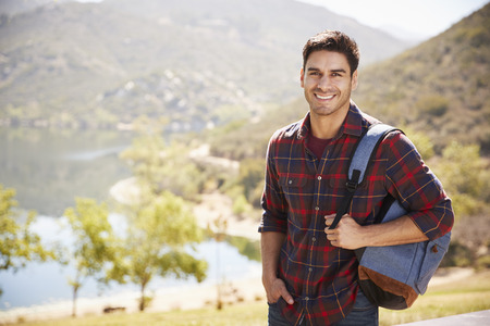Young Hispanic man standing during mountain hike, portrait
