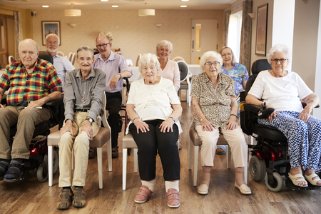 Portrait Of Senior Residents Of Retirement Home Sitting In Loungeの写真素材