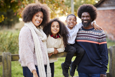 Portrait Of Family On Autumn Walk In Countryside Together
