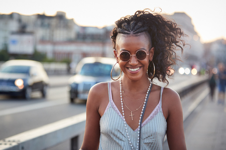 Trendy woman in striped camisole and sunglasses, portraitの写真素材