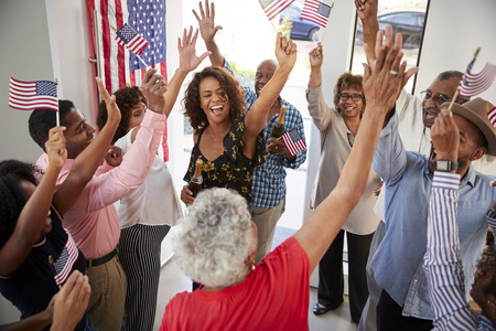 Three generation black family celebrating Independence Day together at home,elevated viewの写真素材