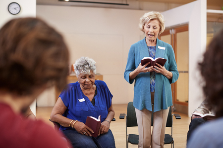 People Attending Bible Study Or Book Group Meeting In Community Centerの写真素材