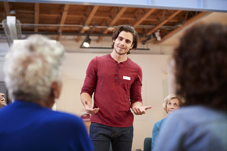 Man Standing To Address Self Help Therapy Group Meeting In Community Centerの写真素材