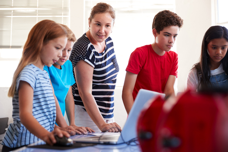 Group Of Students In After School Computer Coding Class Learning To Program Robot Vehicleの写真素材