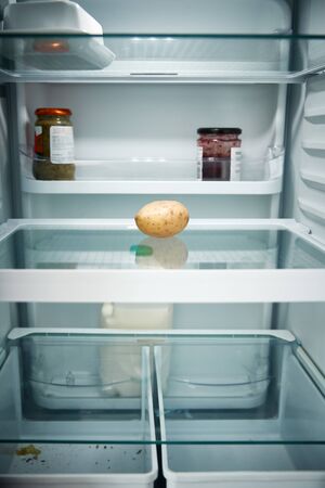 View Looking Inside Refrigerator Empty Except For Potato On Shelfの写真素材