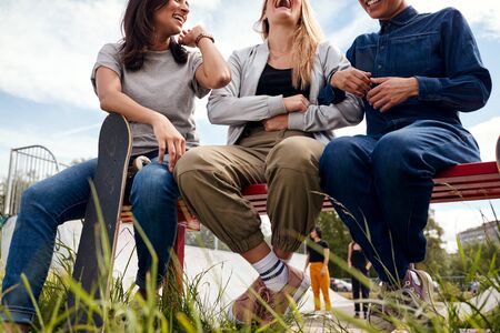 Group Of Female Friends With Skateboard Meeting In Urban Skate Park