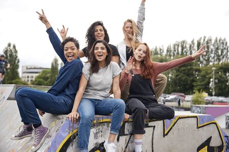 Young Woman Riding On Skateboard In Urban Skate Parkの写真素材