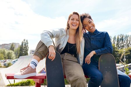 Portrait Of Two Female Friends With Skateboard In Urban Skate Parkの写真素材