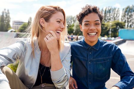 Portrait Of Two Female Friends With Skateboard In Urban Skate Parkの写真素材