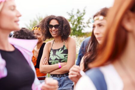 Group Of Young Friends Waiting Behind In Queue At Entrance To Music Festival Siteの写真素材