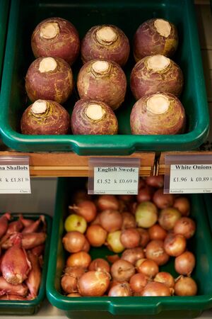 Display Of Swedes And Onions In Organic Farm Shop