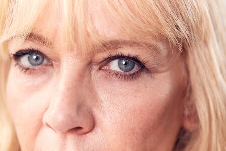 Studio Close Up Of Mature Woman Looking Suspicious And Distrustfulの写真素材