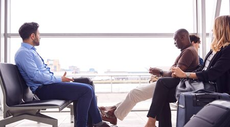 Business Passengers Sitting And Waiting In Airport Departure Loungeの写真素材