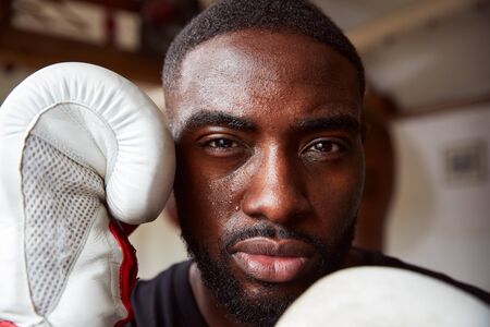 Close Up Portrait Of Male Boxer In Gym Wearing Boxing Glovesの写真素材