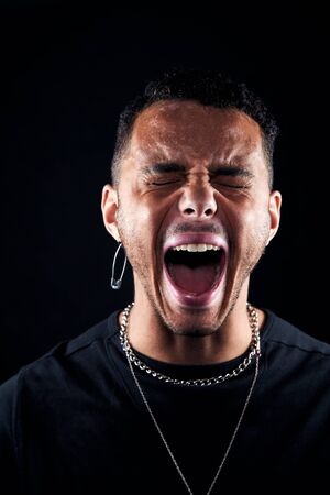 Head And Shoulders Studio Shot Of Angry Man Shouting At Camera