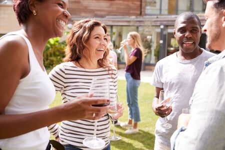 Group Of Multi-Cultural Friends Relaxing And Drinking Wine At Summer Garden Party Togetherの写真素材
