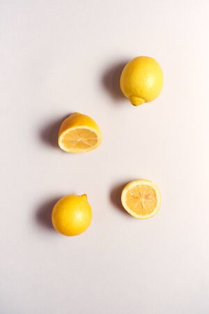 Overhead View Of Whole And Halved Fresh Lemons On White Backgroundの写真素材