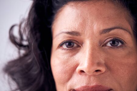 Close Up On Eyes Of Smiling Mature Woman In Studioの写真素材