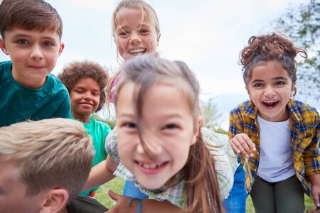 Portrait Of Children On Outdoor Activity Camping Trip Having Fun Playing Game Togetherの写真素材
