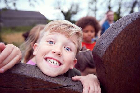 Portrait Of Children On Outdoor Activity Camping Trip Having Fun Playing Game Togetherの写真素材