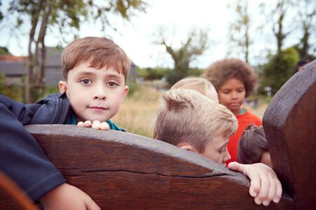 Portrait Of Children On Outdoor Activity Camping Trip Having Fun Playing Game Togetherの写真素材