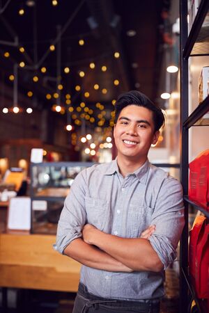 Portrait Of Male Coffee Shop Owner Standing By Counterの写真素材