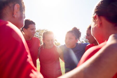 Manager In Huddle With Womens Football Team Giving Motivational Pep Talk Before Soccer Matchの写真素材