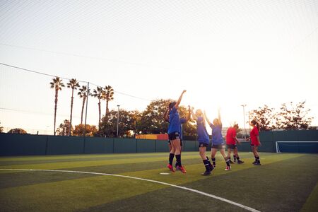Womens Football Team Celebrating Scoring Goal In Soccer Match On Outdoor Astro Turf Pitchの写真素材