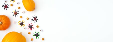 Overhead Halloween Banner Composed Of Pumpkins With Candy Spiders And Eyeballs On White Backgroundの写真素材