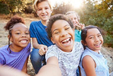 POV Shot Of Multi-Cultural Children Posing For Selfie With Friends In Countryside Togetherの写真素材