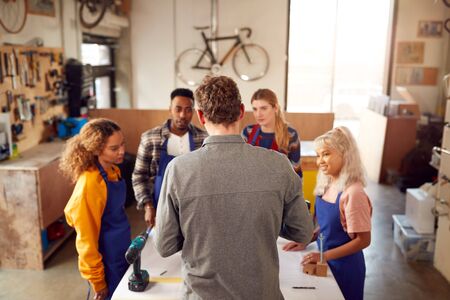 Multi-Cultural Team In Workshop Assembling Hand Built Sustainable Bamboo Bicycle Frameの写真素材